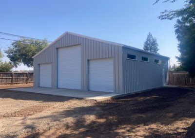 White pre-engineered PEMB Metal Shop Building with white roll up doors butte county