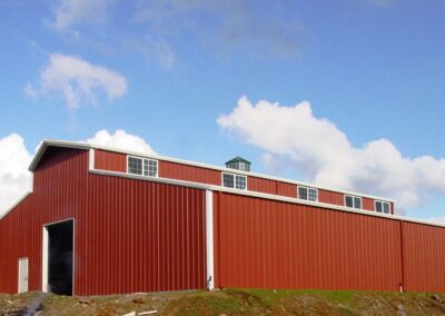 Large Red Metal Barn with White Roll Up Door Butte County